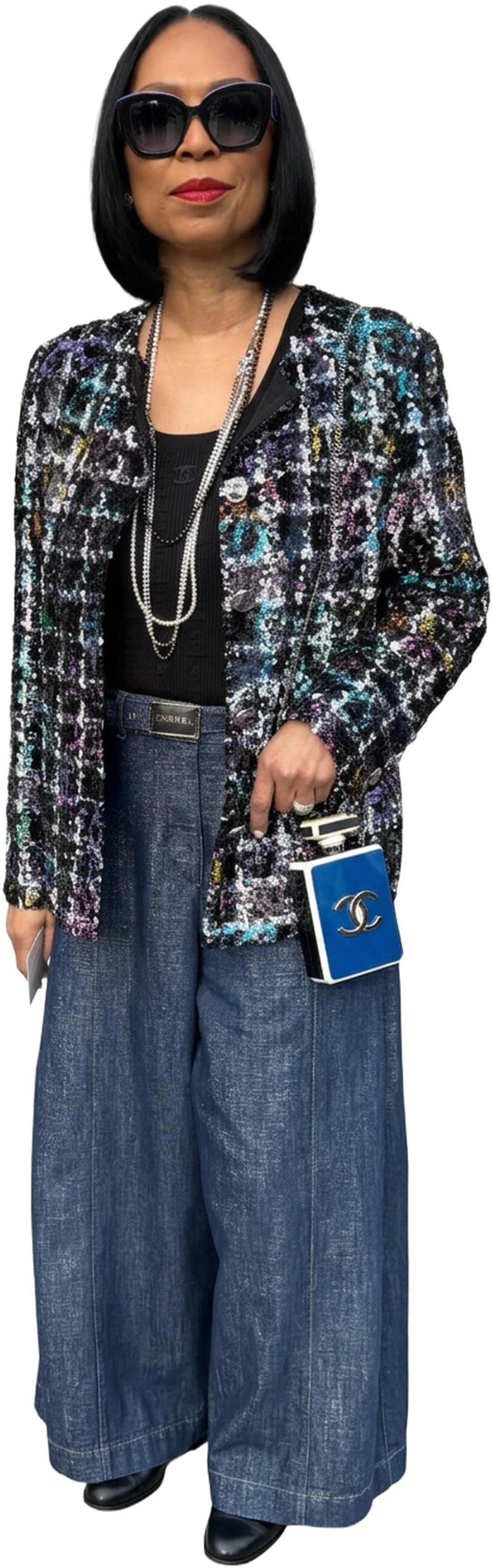 Patricia Lewis in a sparkly tweed jacket, wide-leg denim and a blue Chanel perfume-bottle clutch